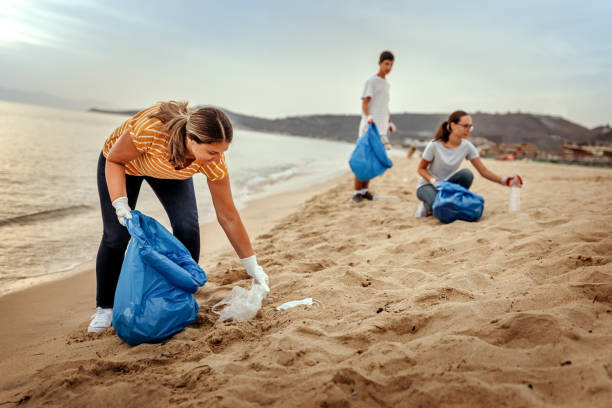 istock Volunteers picking up plastic waste and cleaning beach 1353220814