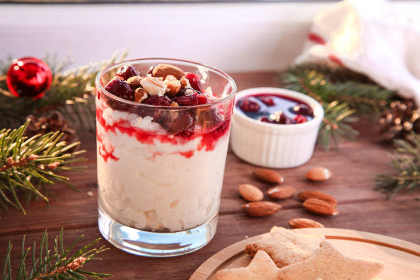 istock Christmas rice pudding with almonds and cherries on wooden background. Risalamande 1353222057