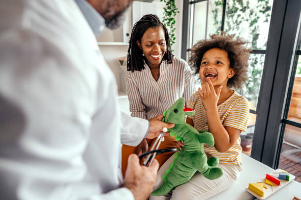 istock Mother and daughter at pediatrician's office 1353222467