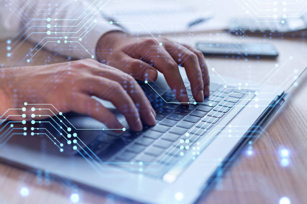 istock Hands typing the keyboard to create innovative software to change the world and provide a completely new service. Close up shot. Hologram tech graphs. Concept of Dev team. Formal wear. 1353223280