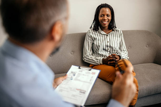 Woman talking to therapist at office during treatment
