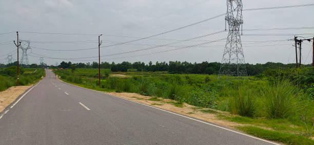 istock Concrete Road with electric tower 1353226731
