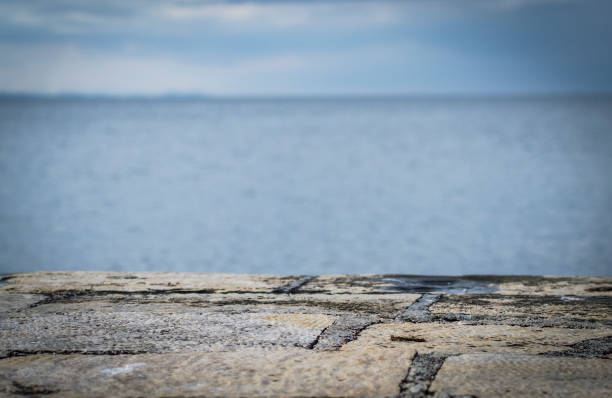 istock Stone dock and blurred sea background. Perfect for montage or product display 1353232468