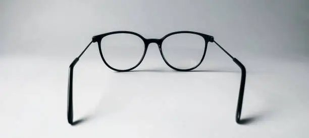 Rear view eyeglasses with black frames isolated on white background.