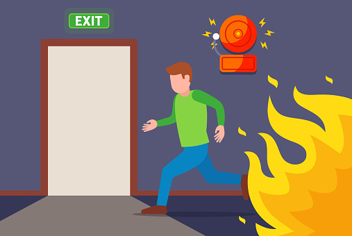 a man runs from the fire to the evacuation door. escape the fire. flat vector illustration.