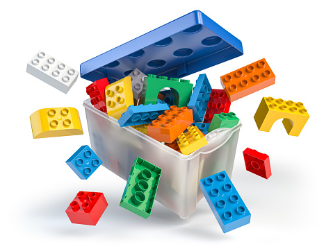 Box full of colorful toy plastic bricks and blocks isolated on white. Delivery children gifts and toys. 3d illustration