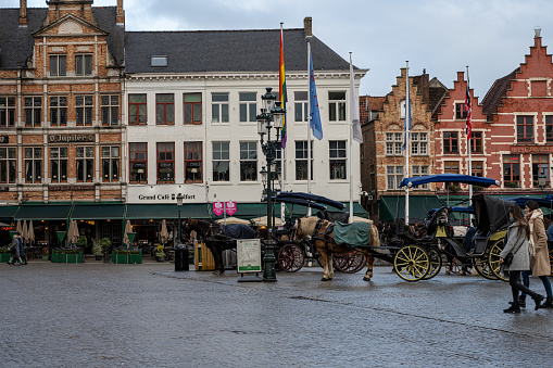 Bruges, Belgium - April 28 2018:   A horse and cart trots through the streets on a tourist trip