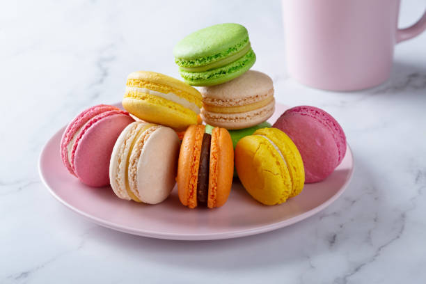 istock Sweet french macaroons and coffee on white table. 1353241150