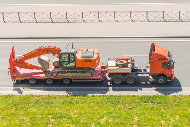 truck carrying excavator
