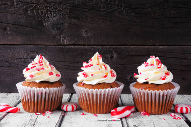 istock Christmas peppermint cupcakes  in a row against rustic wood 1353245901