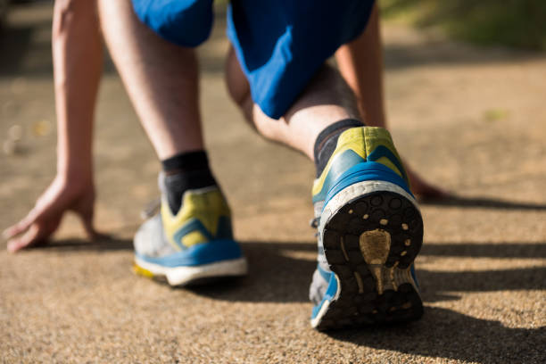 istock Rear runner running shoes start to run in park 1353247685
