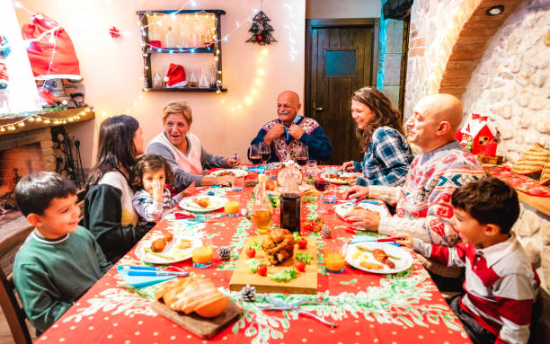istock Large multi generation family having fun at holidays dinner event - Winter x mas concept about grand parents eating together with children at home supper feast - Focus on grandfather in the middle 1353250230