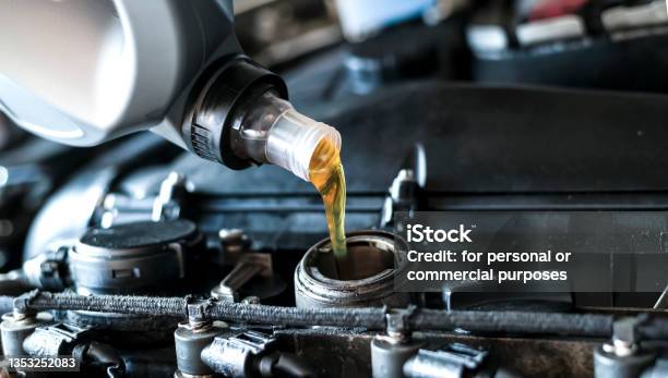 Close Up Of Pouring Synthetic Motor Oil In Diesel Engine Stock Photo - Download Image Now