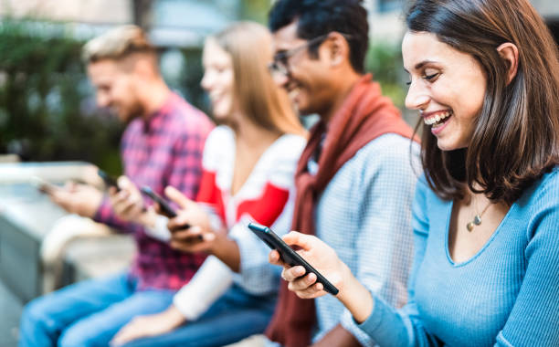 istock Multicultural group using smartphone at urban city context - Milenial friends addicted by mobile smart phones - Technology concept with always connected millennials with focus on right woman 1353253661