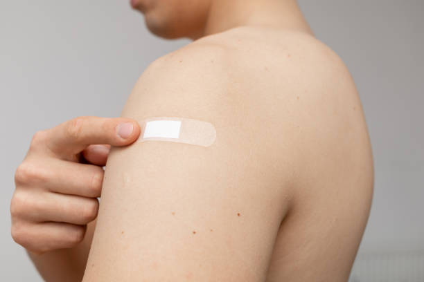istock happy man pointing at the patch on shoulder 1353254676