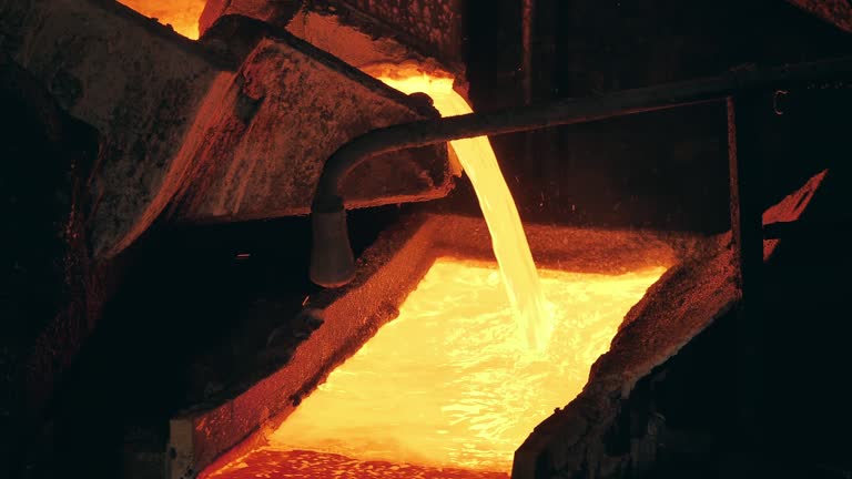 Foundry mechanism is pouring molten copper into a mold