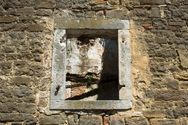 Window of an old abandoned and ruined stone house in a small village Oprtalj Portole in central Istria, Croatia