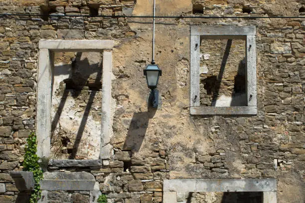 Windows of an old abandoned and ruined stone house in a small village Oprtalj Portole in central Istria, Croatia