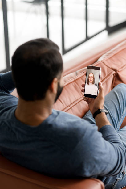 istock Vertical shot of Indian man resting using mobile dating app 1353257813
