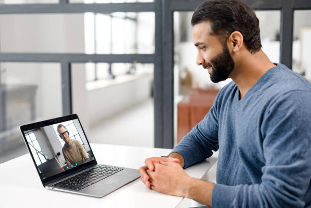 istock Two male diverse colleagues talks via video call 1353259276