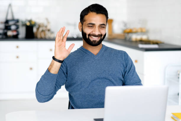 istock Young indian male employee is using video connection for virtual meeting 1353259622