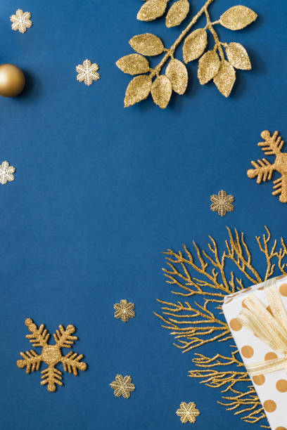 istock Christmas holiday composition. Flat lay frame with christmas balls and gift box on a blue background 1353261978