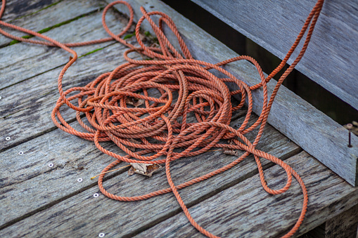Orange nylon rope on a wooden floor