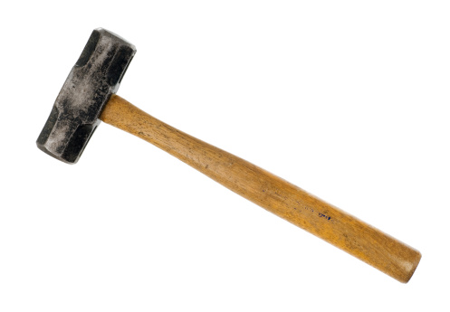 A very well used big hammer isolated on a white background.