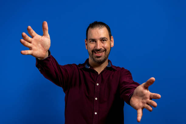 istock Young caucasian man isolated on blue background showing a welcome expression 1353262562