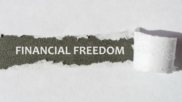 istock the text Financial Freedom appearing behind torn white paper, gray background 1353265933