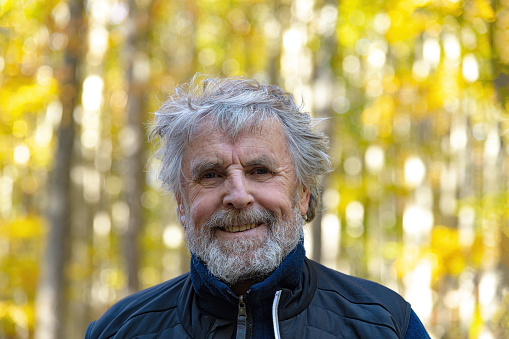 Portrait of a senior man with a gray beard in the autumn mountains, Primorska, Julian Alps, Slovenia, Europe