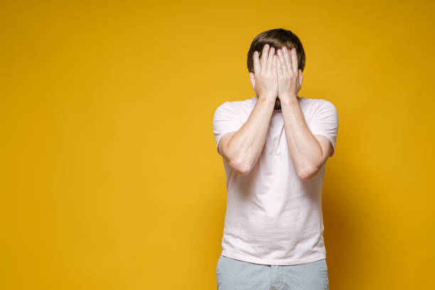 istock Caucasian man covered his face with his hands. He is upset, stressed and very tired. Copy space. Psychological concept. 1353268600