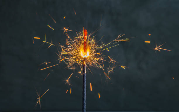 istock Burning sparkler, on a blue background, happy new year 1353268981
