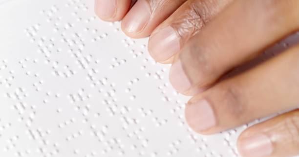 istock fingers are reading braille 1353270316