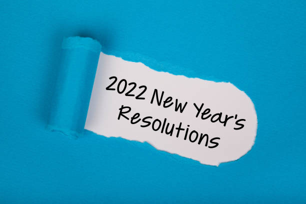 istock Torn Paper With New Year 2022 Resolutions On White Background 1353270395