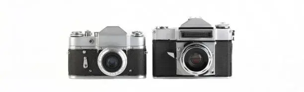 Photo of MOSCOW, RUSSIA, NOVEMBER 14, 2021. Very rare old Soviet 35 mm SLR camera Zenit-4 and Zenit 3, released 1967 and 1961 on white background.