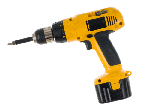 Well used cordless drill/screwdriver isolated on a white background.