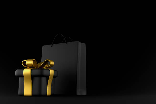 istock Black shopping bag and black gift box on a black background. Mock up. 3d rendering 1353271682