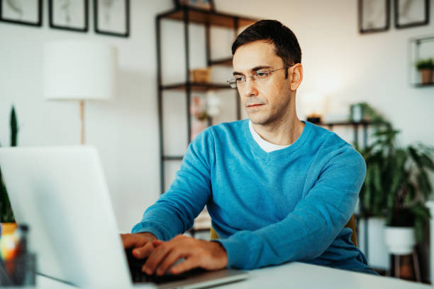 istock Serious businessman working on laptop 1353271763