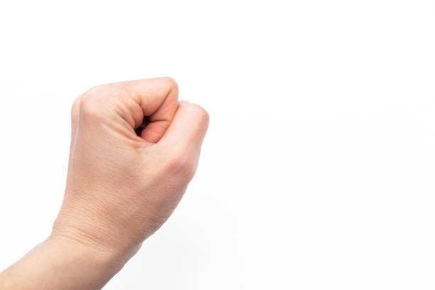 istock fisted tight female hand isolated on a white background. Copy space. Banner 1353272583