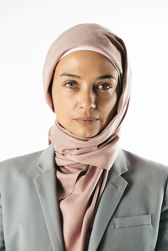 Muslim woman in gray with rose headscarf.