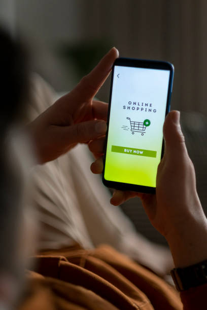 istock Man shopping by mobile phone laying at home. 1353275976