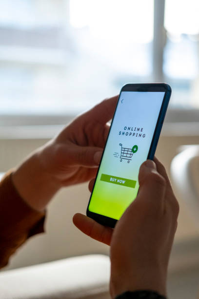 istock Man shopping by mobile phone laying at home. 1353277012