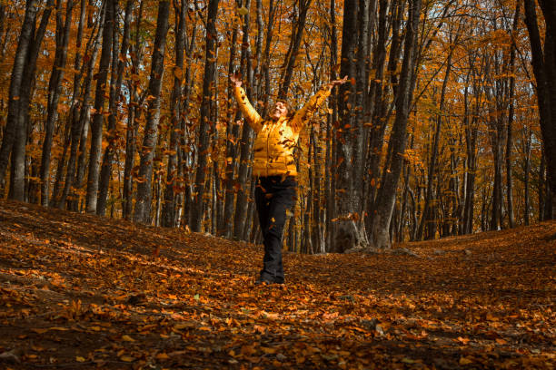 istock Happy young woman autumn forest. 1353278728