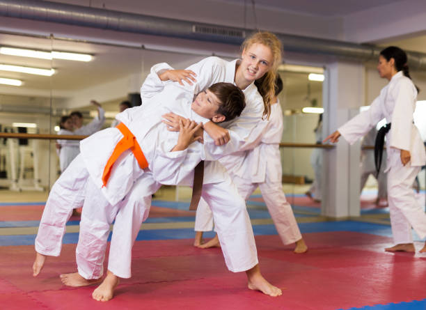 istock Girls and boys on aikido training 1353281888