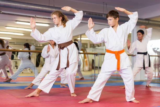 istock Kids in karate uniform performing kata 1353281897