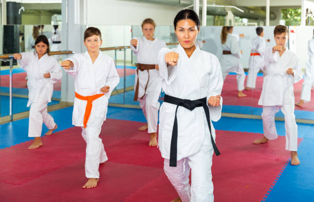 istock Karate kids doing kata in gym 1353282170