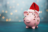 Christmas Savings Background with Pink Piggy Bank Wearing Santa Hat