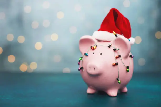 Photo of Christmas Savings Background with Pink Piggy Bank Wearing Santa Hat