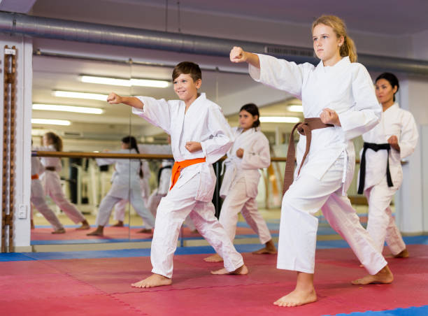 istock Karate kids doing kata in gym 1353282264